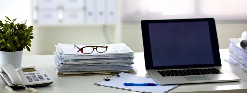 Desk with papers and laptop